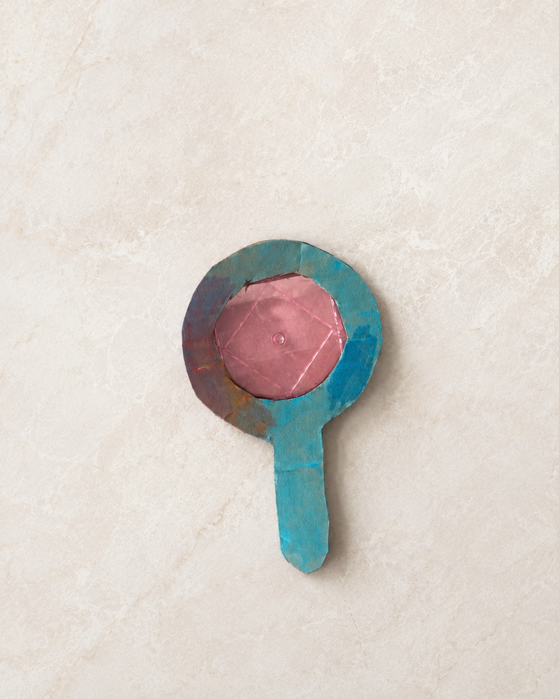 Preschool cardboard magnifying glass craft painted blue with a pink center