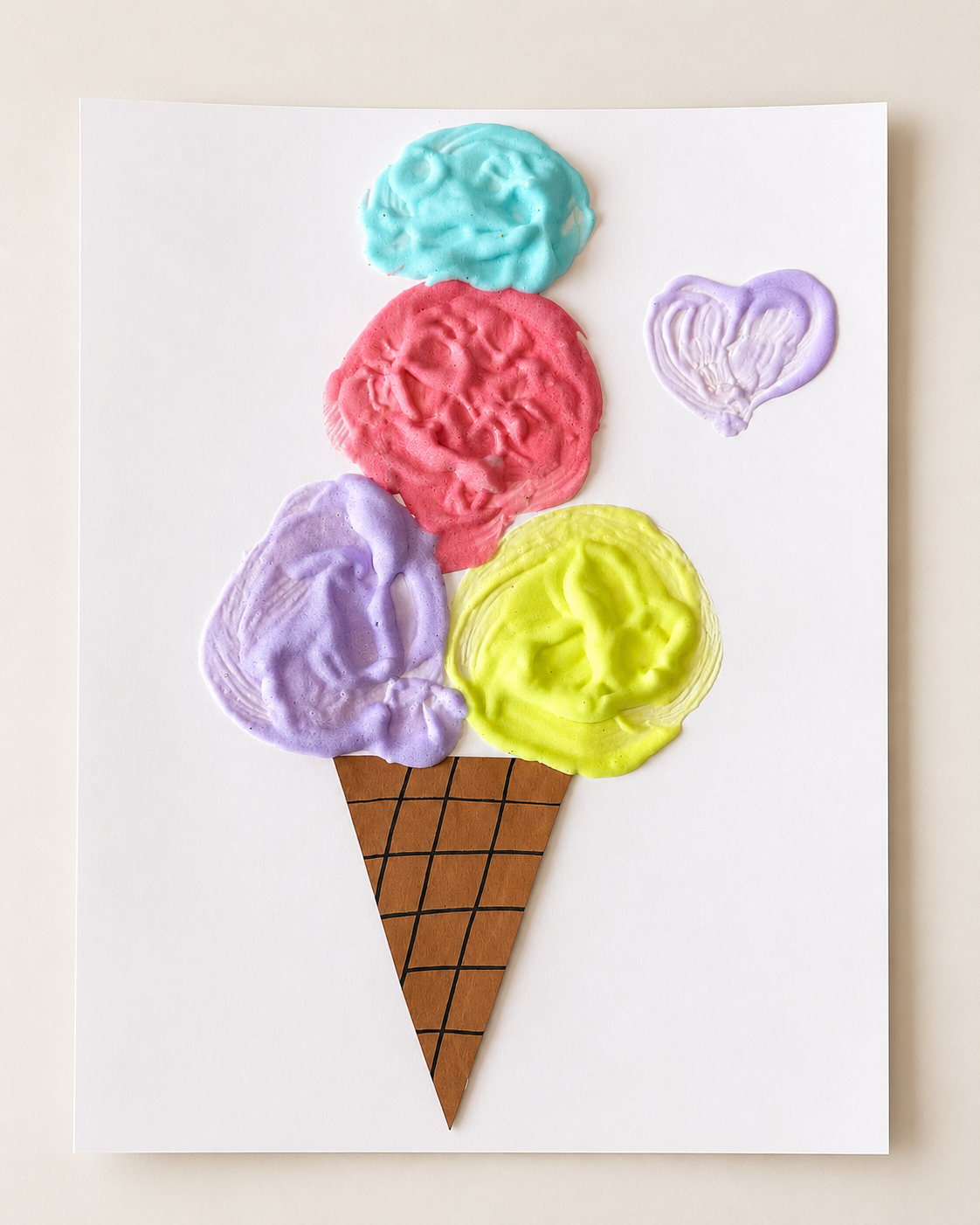 Puffy paint ice cream craft with colorful shaving cream paint scoops and a paper cone