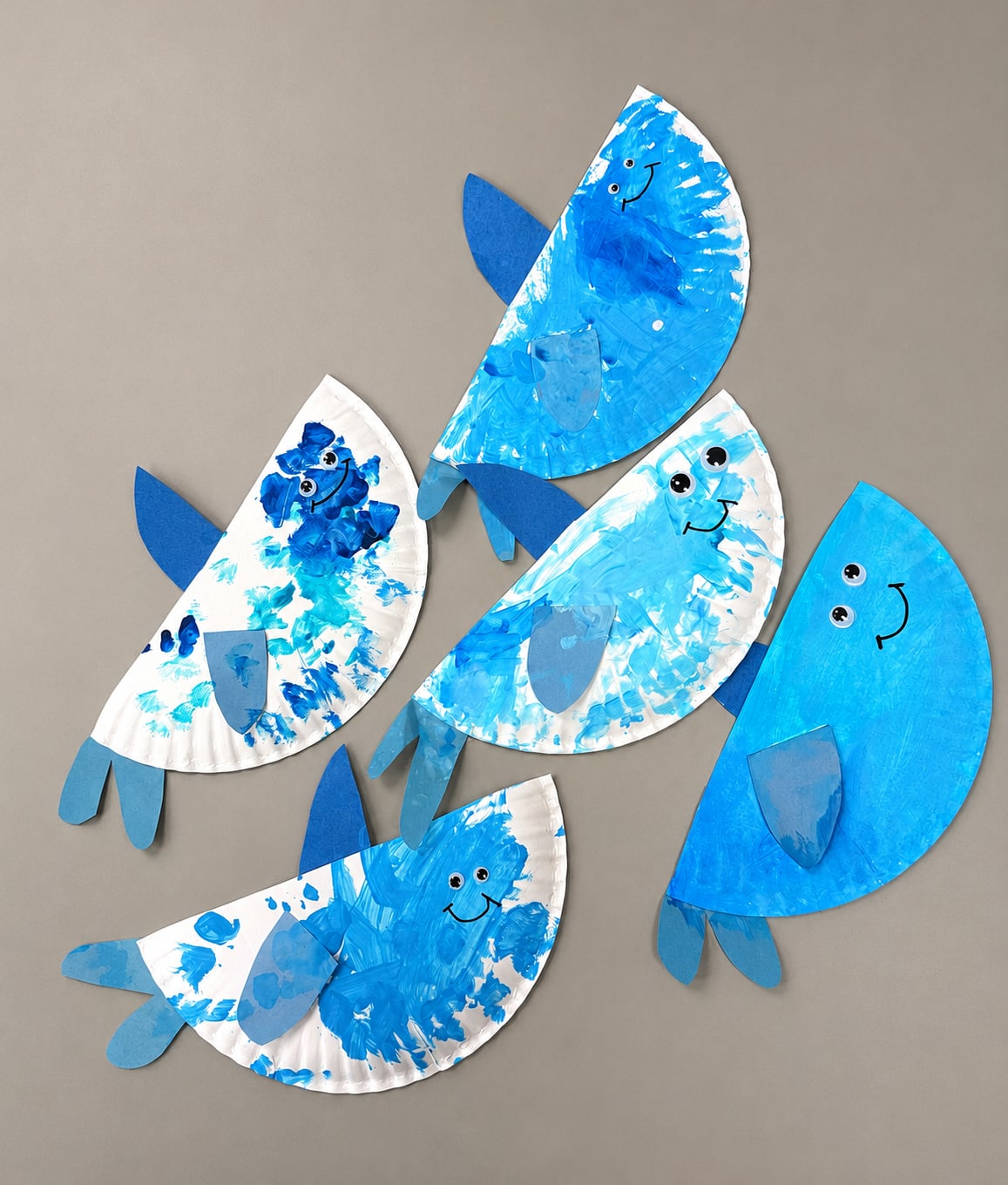 Blue paper plate shark craft made by preschool children